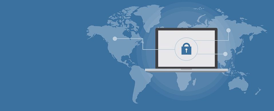 Image contains a map and a laptop with a picture of a lock on it.